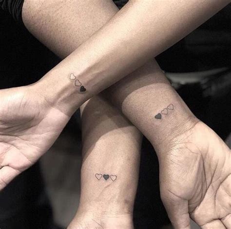 3.5 crossed arrows with initials; Three hearts makes one, matching tattoos done by ...