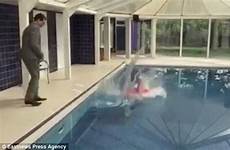 pool pushed swimming her woman down being placing filmed quickly bending stand again going hand before behind gives