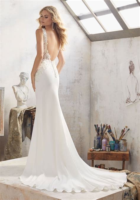 Made from satin back crepe the contemporary shape and deep frill show off just enough skin while still leaving plenty to the imagination. Mallory Wedding Dress | Style 8113 | Morilee