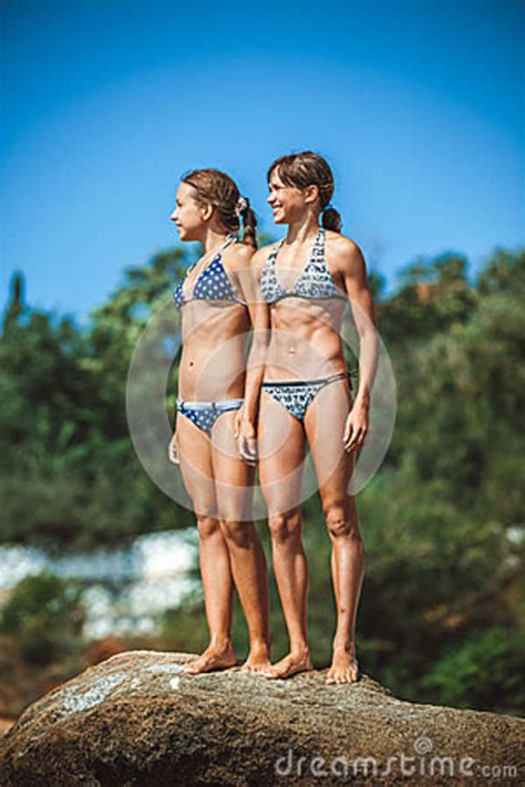 Very young and very beautiful girls sets. Young Girls On Stones On A Beach Stock Image - Image of ...