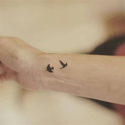 Black small wrist tattoo ideas. Two little birds on the wrist. Tattoo artist: Lu Reis ...