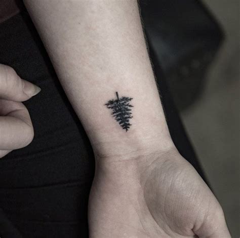 You can either get a black outline of a crown, or you can make it detailed. Tree Tattoo on Wrist by Georgia Grey | Wrist tattoos for guys, Small tattoos for guys, Cool ...