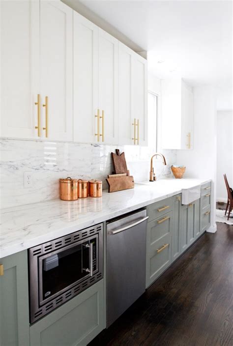 For example, sleek black cabinetry with a high gloss sheen paired next to a light brown wood can bring more variation to the kitchen. Tips For Pulling Off Two Tone Kitchen Cabinets