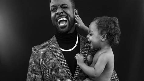 Father holding newborn baby over black background stock. Free download 21 Powerful Images Of Black Fathers In ...