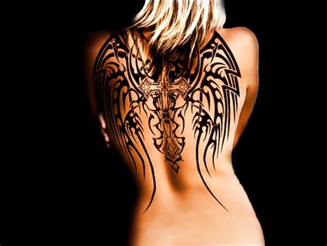 The cross has just enough small, feminine details that it matches up perfectly to the bolder, more masculine lines of the wings wrapped around it. 35 Insanely Gorgeous Wings Tattoos -DesignBump