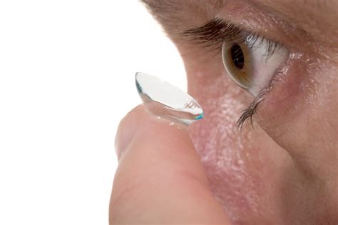 Contact lens wear and care. close-up of contact lens and eye 1 - Magruder Eye Institute