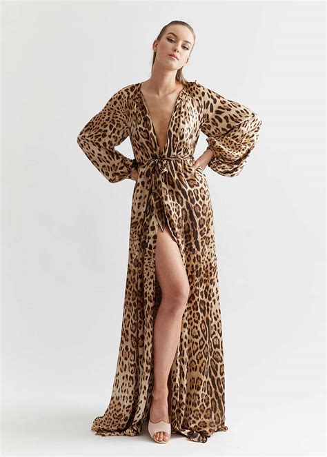 A woven robe featuring an allover leopard print, piped trim, round vented collar, and a removable sash belt. Stellar Silk Leopard Peignoir | Celeste