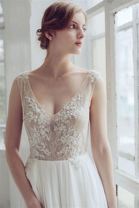 It's traditional, but has a low cut and a tie at the back of the neck give it a bit of extra personality. 20 Chic & Sheer Wedding Dresses from Etsy | SouthBound Bride