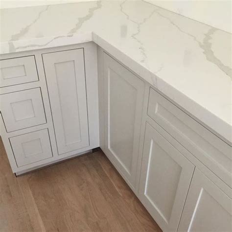 The transitional kitchen's masterpiece is the gorgeous hood with a great island! cabinet paint color - Balboa Mist | Kitchen cabinet colors, French country bathroom, Cabinet ...