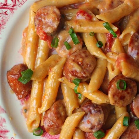 Add the pasta, tomatoes, stock, and cream. ONE PAN CHEESY SMOKED SAUSAGE & PASTA RECIPE #dinner # ...