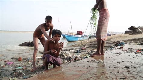 Arab and asian twinks collide. VARANASI, INDIA - 25 FEBRUARY 2015: Man Washing With Water ...