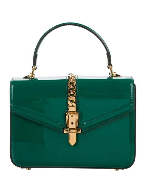 Coming in various styles and sizes, the baguette the lv tribute patchwork bag is the most expensive handbag that the company has ever produced. Gucci Sylvie 1969 Patent Mini Top Handle Bag - Handbags ...