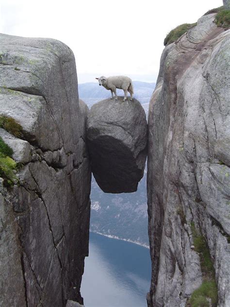 Kjeragbolten a rock balanced between two cliffs in Norway ...