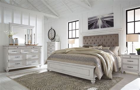 The planked headboard radiates farmhouse style. Kanwyn Upholstered Panel Bedroom Set by Benchcraft ...