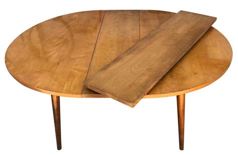 Patterns were engraved on it by a skillful artisan. Round Rare Leslie Diamond Maple Dining Table with 2 Leaves Tapered Legs at 1stdibs