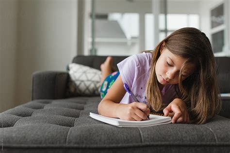 Get durable lounge seating that looks good in your school. Preteen Girl Writing In A Journal While Laying On Sofa At ...