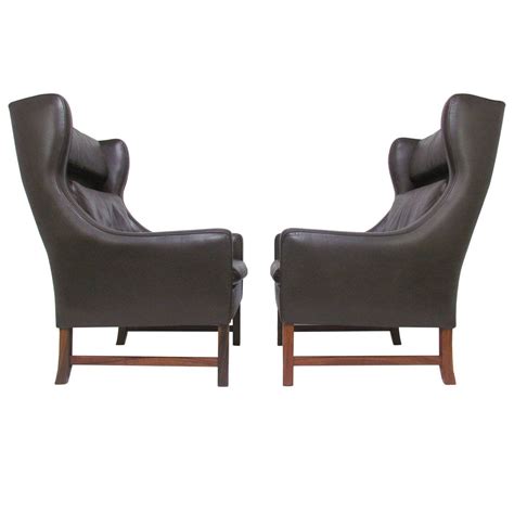 Unique modern wing chair with double row of shiny nickel nailheads and exposed wood feet. Pair of Danish Modern Wingback Leather Lounge Chairs by ...