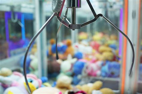 We break the budget for stuffed plush into three parts: Close Up Of The Doll Claw Machine Of Games Arcade In ...