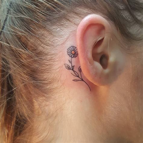 This may include tiny ladybugs climbing the stem, butterflies hovering nearby or even a caterpillar climbing the stalk. tattoos-org: " Daisy Behind the Ear Tattoo Artist: Megan ...