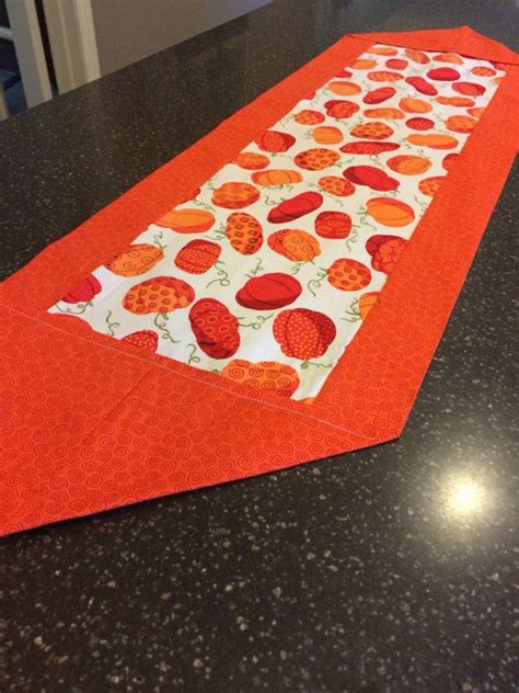 A 7 inch embroidery project with a floral wreath. Fall Pumpkin Table Runner | Pumpkin table runner, Fall ...