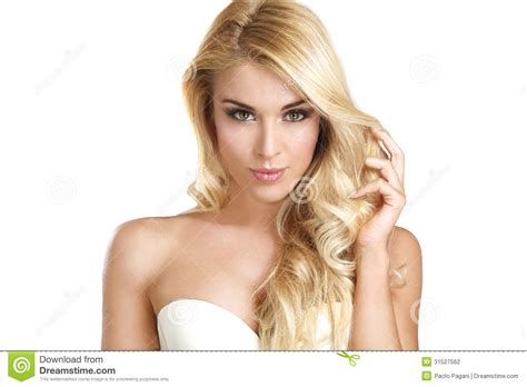 Long blonde hairstyles have always been associated with femininity, grace and elegance. Young Beautiful Woman Showing Her Blonde Hair Stock Photo ...