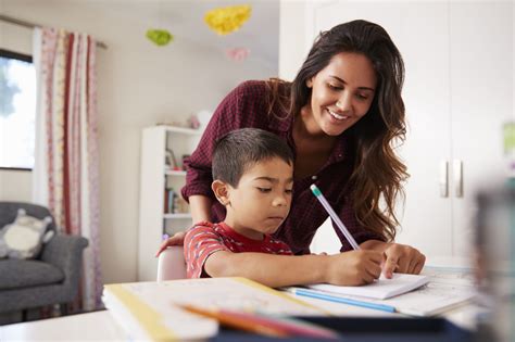 Check spelling or type a new query. Mother Helping Son With Homework Sitting At Desk In ...