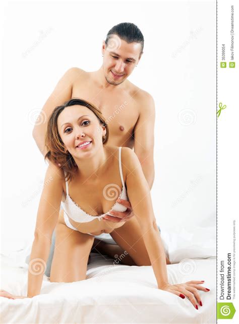 It shows that the man is somewhat hesitant to begin a conversation with her.so, dont hesitate bos the woman wont eat you up, on the contrar. Man And Woman Playing Together In Bed Stock Images - Image ...