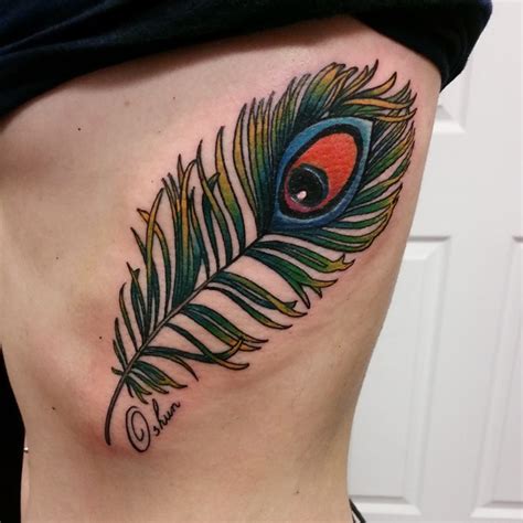 Feather tattoo comes with various meanings and interpretations; 35 Colorful Peacock Feather Tattoo - Meaning & Designs (2018)