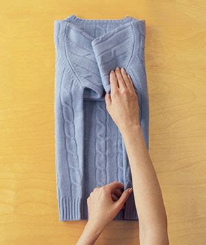 Make sure the sweater is folded with the armpit of the sweater close to the neck of the hanger. How to Fold a Sweater - Real Simple