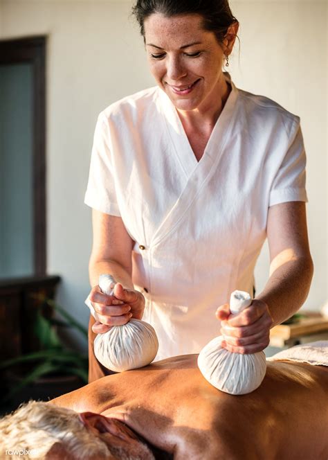 Female message therapist giving a massage at a spa | premium image by rawpixel.com / Chanikarn