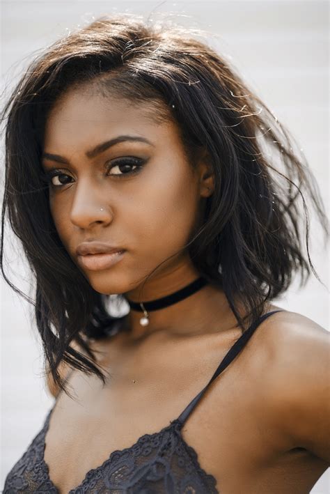Beautiful multicultural female models in fashionable black and white clothes sitting on black cube and looking at camera on white. DiiWilson Female Model Profile - Baltimore, Maryland, US ...