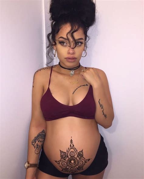 Pregnant happy woman in indian sari with mehendi tattoo painted with henna on belly, gently support the belly and looks at the henna tatoo on pregant belly. de683438578a414e13d97f9ae27acee3-henna-tattoos-belly ...