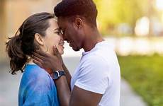 kissing men women young couple multiracial outdoors stock royalty