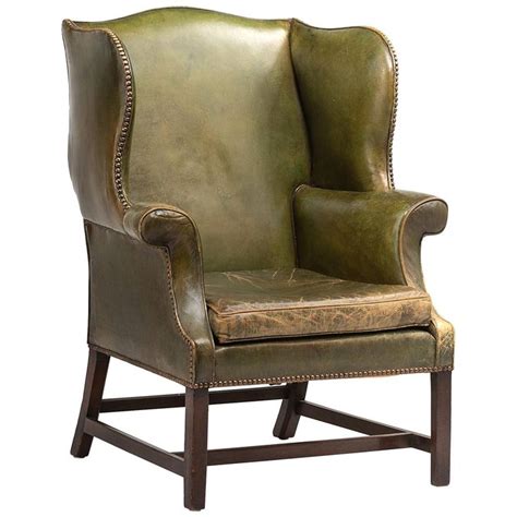 This silhouette comes with a nail head trim that embellishes the flared outline while the emerald green velvet magnetizes the. Green Leather Wingback Chair, circa 1920 | Leather ...