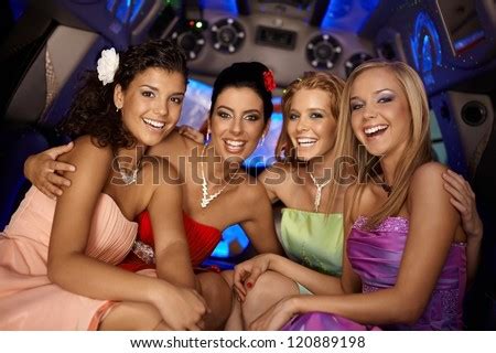 Some that are shy, and then there's the others. Beautiful young girls having party in limousine, smiling ...