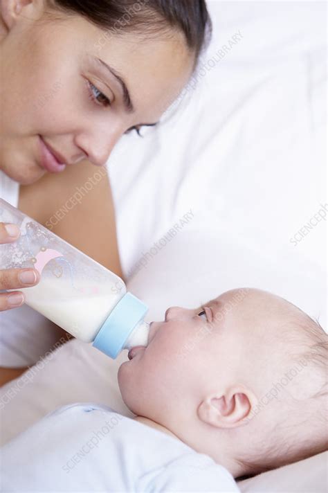Free shipping on qualified orders. Mother giving the bottle to her baby - Stock Image - F003 ...
