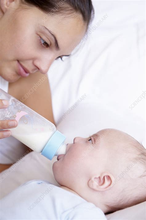 Free shipping on qualified orders. Mother giving the bottle to her baby - Stock Image - F003 ...