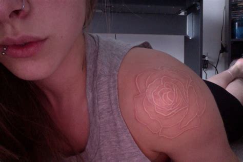 The tattoo has a long tradition as a memorial tattoo with both men and women. White ink rose tattoo on shoulder | White ink tattoo ...