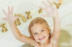 little girl bathtub sitting smiling camera adorable raising hands while