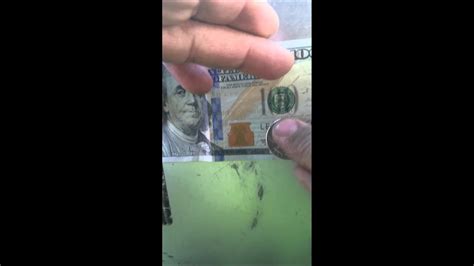 The thread is imprinted with the letters usa and the numeral 100 in an alternating pattern and is visible from both sides of the note. How to check if 100 dollar bill is real - YouTube