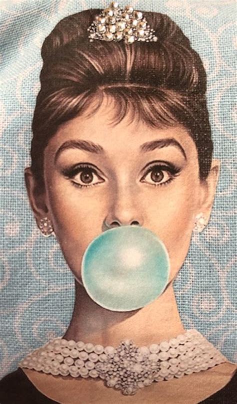 Recognised as both a film and fashion icon. Audrey Hepburn blowing blue bubble with rhinestone tiara ...