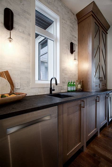 Black countertops can take any kitchen from bland to bold. Butlers pantry with white oak shaker style cabinet with ...