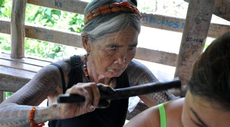 The handmade ink is tapped deep into the skin using the thorn and bamboo to push it in. No single individual can claim ownership Whang-od's tattoo ...