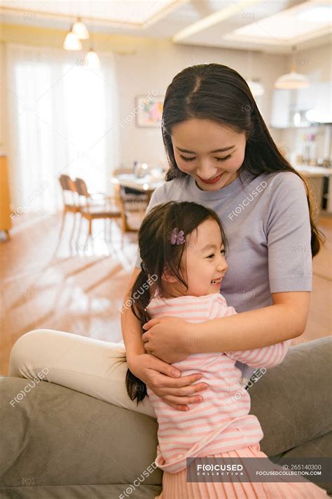 Beautiful happy asian mother and daughter hugging at home — together, cute - Stock Photo