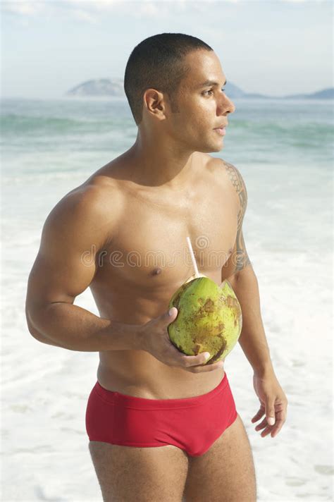 No visit to rio is complete without experiencing the beach life or a walk along the scenic promenades of these beautiful coasts. Athletic Brazilian Man Drinking Coconut Rio Beach Stock ...