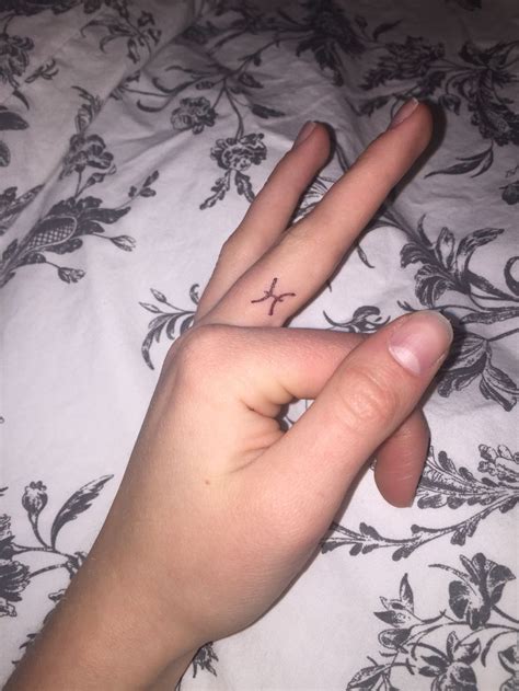 This symbol is a popular tattoo amongst women who follow the path of the goddess, are wiccan, or believe in paganism. Pisces finger Tattoo | Pisces tattoos, Pices tattoo ...