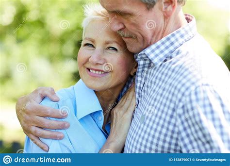 Caring Senior Couple Embracing in Park Stock Image - Image of happy, leisure: 153879007