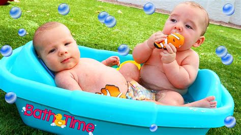 Boy playing with his dog sitting on the grass. Twins Baby Bath Time Cute Finding Nemo Bathtub Toys with ...
