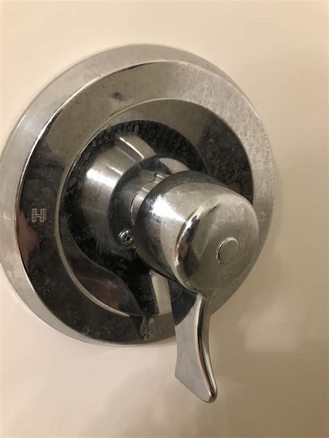 Why should i be careful with the hot/cold button? How do I remove a shower handle with no exposed screws or ...