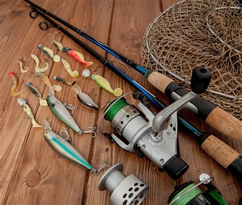 Fishing tackle - fishing spinning, hooks and lures on wooden background with copy space - DP Fishing